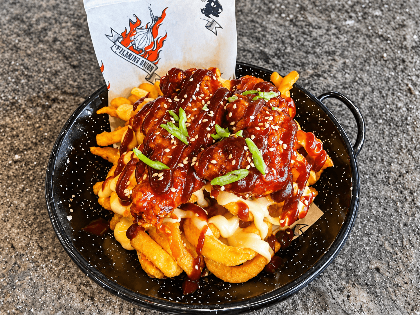 Loaded fries topped with cheese and sauce